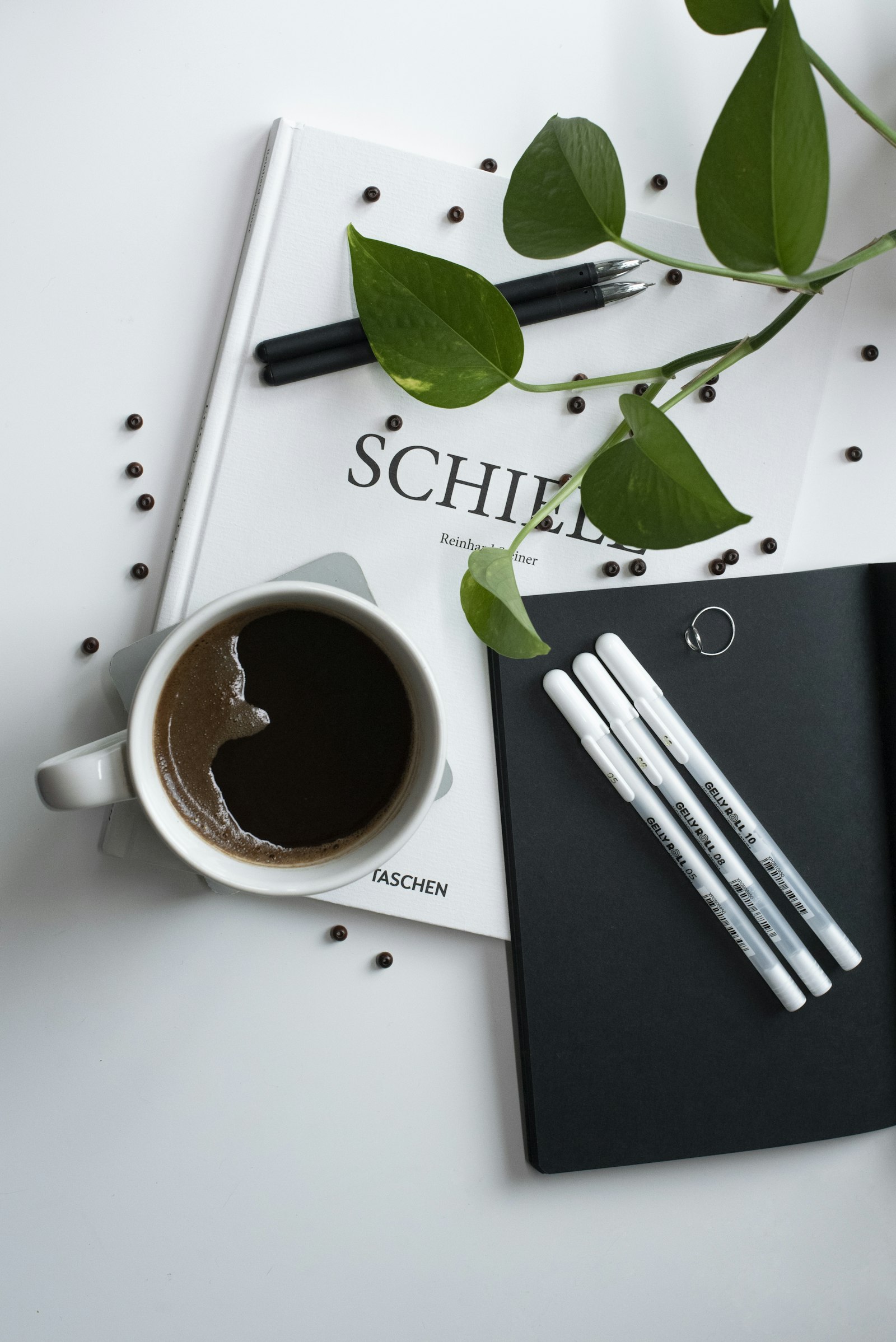 Two espresso cups on a marble surface beside an open notebook
