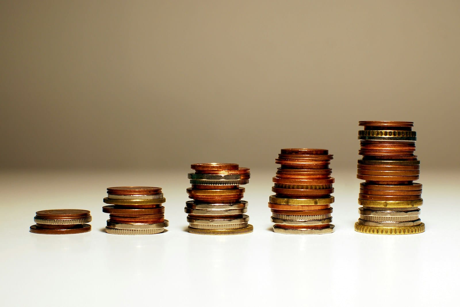 Stacks of coins rising in height from left to right