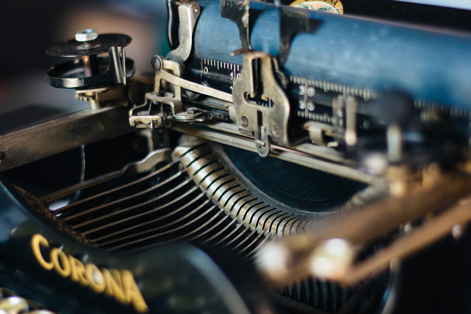Close-up of black typewriter keys catching warm light